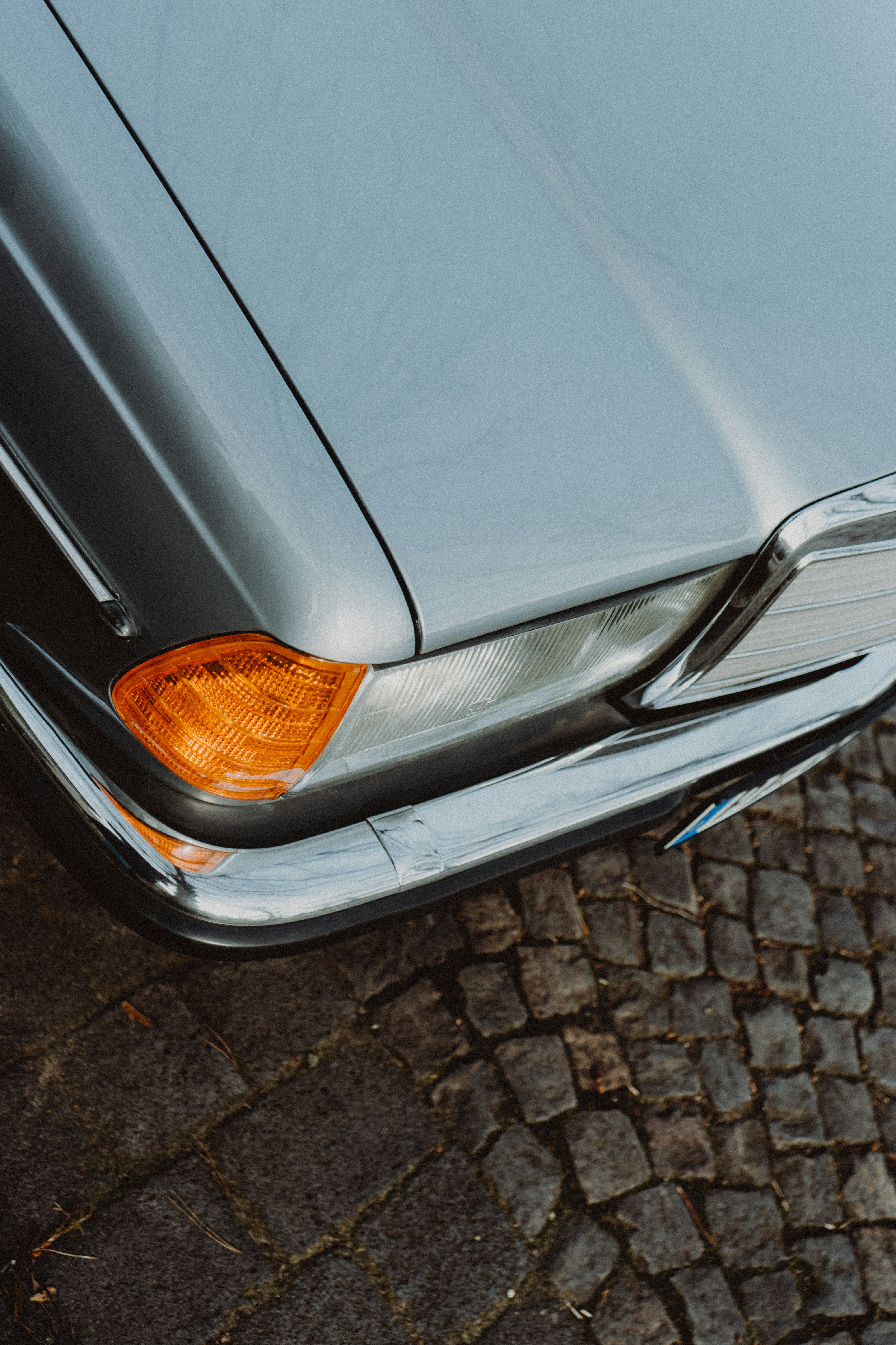 silver car on brown brick floor